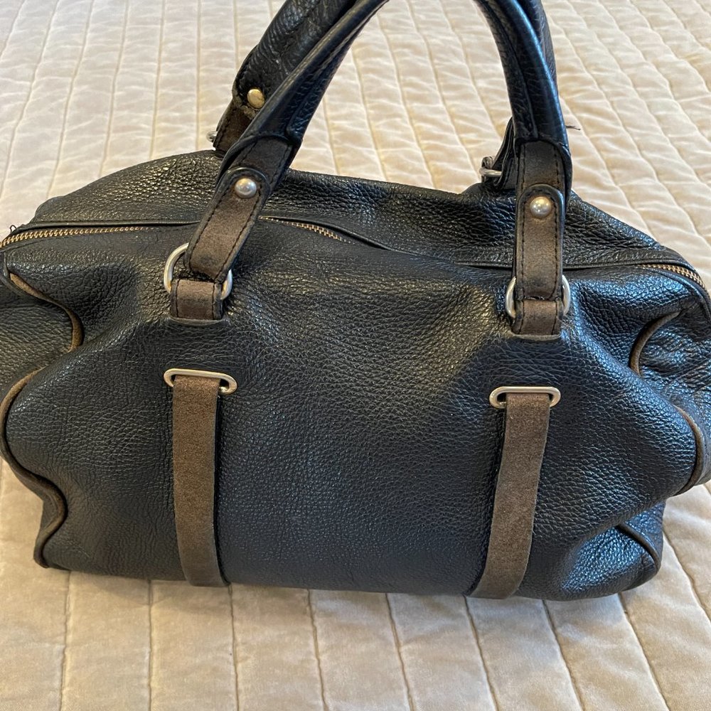 Genuine black leather purse with suede details.